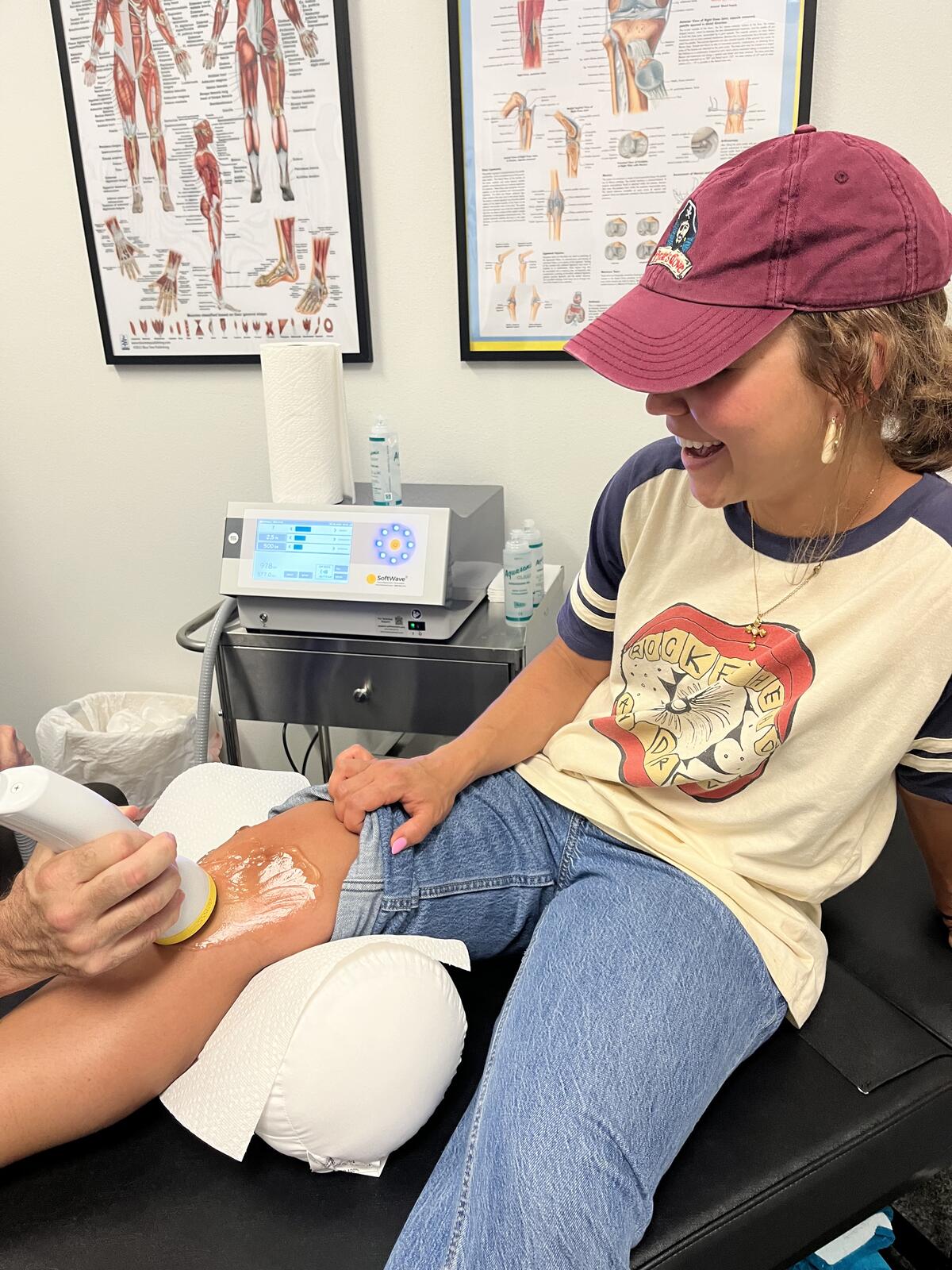 A patient receiving SoftWave shockwave therapy on her knee at our Ormond Beach office
